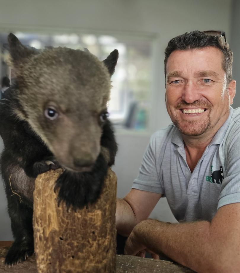 Free The Bears CEO Matt Hunt with a moon bear cub from a record rescue in Laos in March 2023.