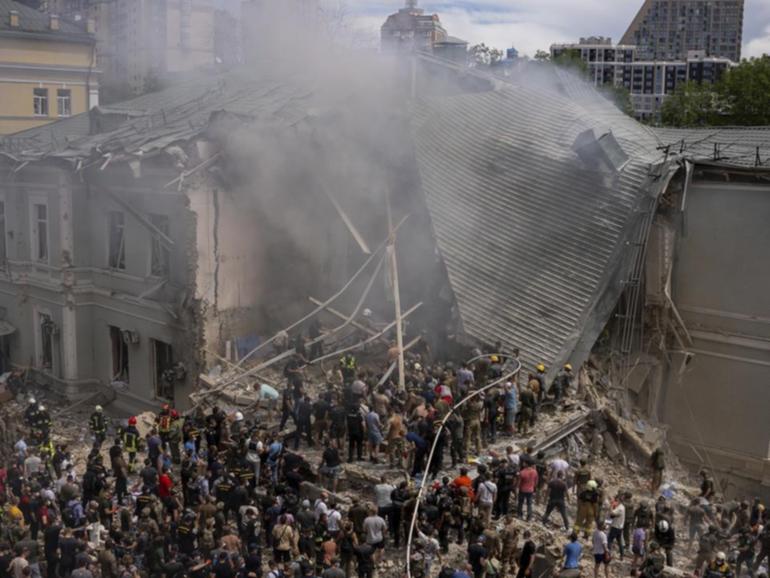 Hundreds of Kyiv residents have helped to clear debris after a hospital was struck by a missile.