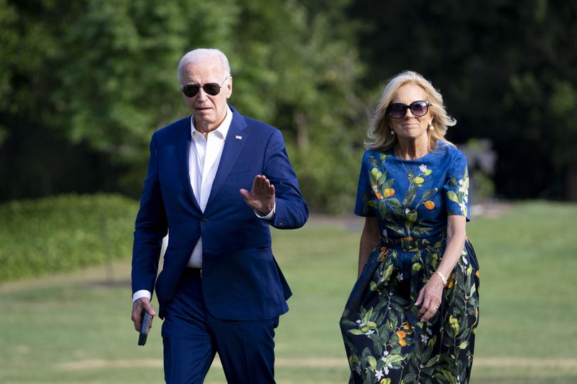 President Joe Biden and first lady Jill Biden walk off Marine One on the South Lawn of the White House in Washington.