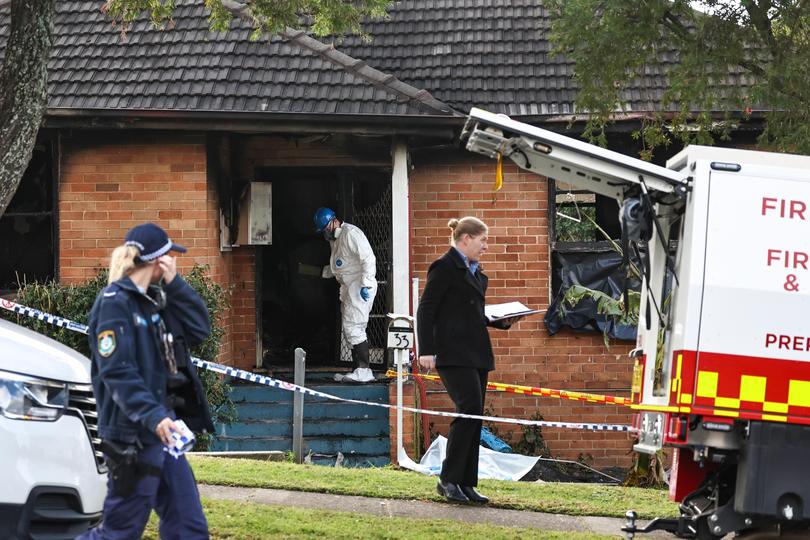 Forensic officers, Fire and Rescue Officers and police investigate a fire damaged house in Lalor Park in Sydney, Sunday, July 7, 2024. Three young children have died and four other children were lucky to escape a house fire in Sydney's west as police investigate the cause of the blaze. (AAP Image/Mark Evans) NO ARCHIVING MARK EVANS