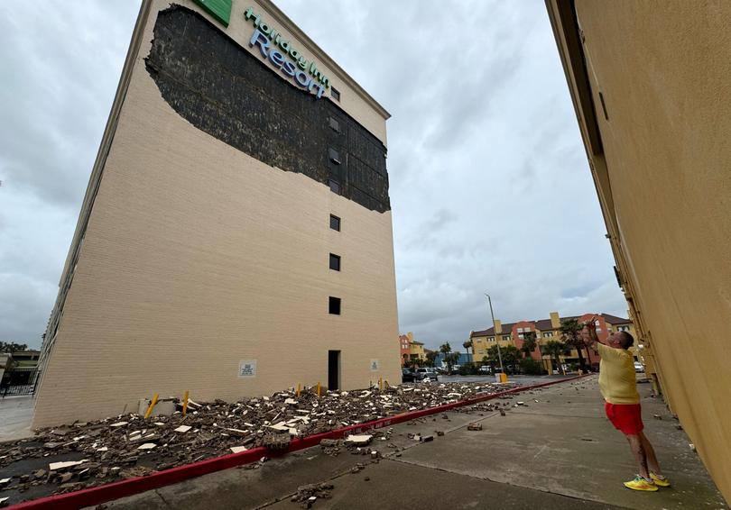 Jeff Reding 57, looks at damage to the Holiday Inn resort in Galveston left by Hurricane Beryl.