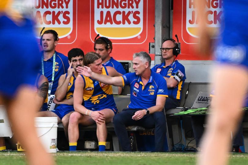 Adam Simpson talks with Harley Reid on the bench. 