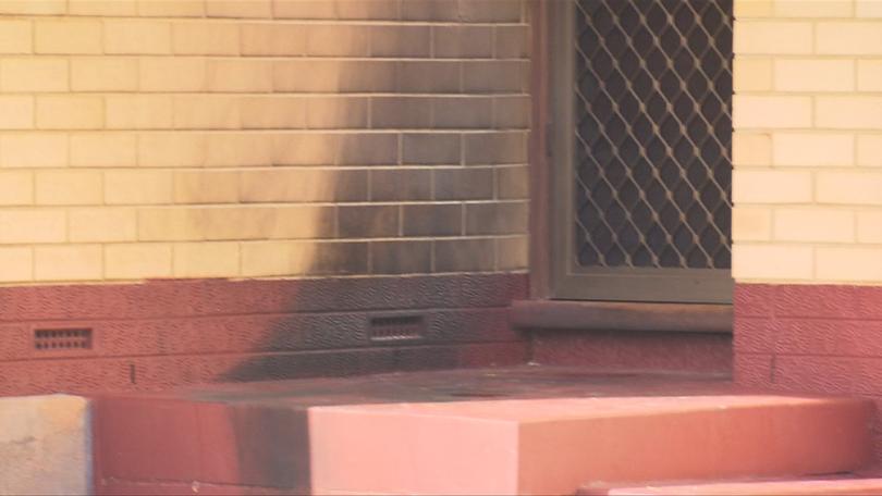 An Adelaide man allegedly poured petrol on the front door of the home and set it alight while four people were inside.