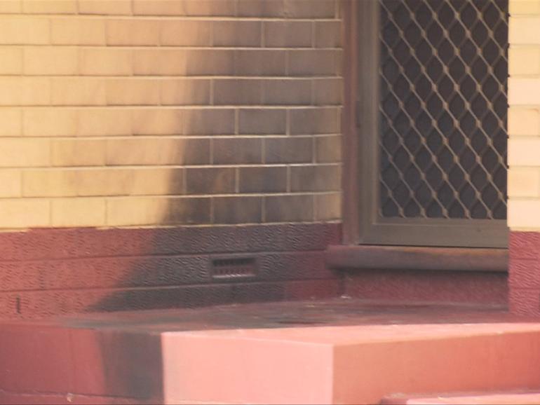 An Adelaide man allegedly poured petrol on the front door of the home and set it alight while four people were inside. 