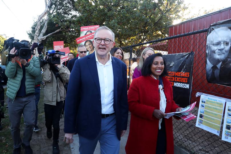 MELBOURNE, AUSTRALIA - MAY 21: Labor Leader Anthony Albanese alongside Labor candidate Dr Michelle Ananda-Rajah (R) meets with voters at a polling booth in the electorate of Higgins on May 21, 2022 in Melbourne, Australia. Australians head to the polls today to elect the 47th Parliament of Australia, with a tight battle between incumbent Prime Minister Scott Morrison of the Coalition party and Labor Leader, Anthony Albanese. The Coalition party has led government since 2013. (Photo by Lisa Maree Williams/Getty Images)