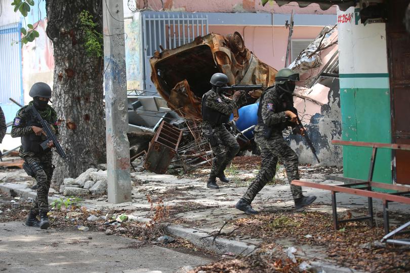 Haitian police patrol near the General Hospital after Haitian Prime Minister Garry Conille visited the facility.