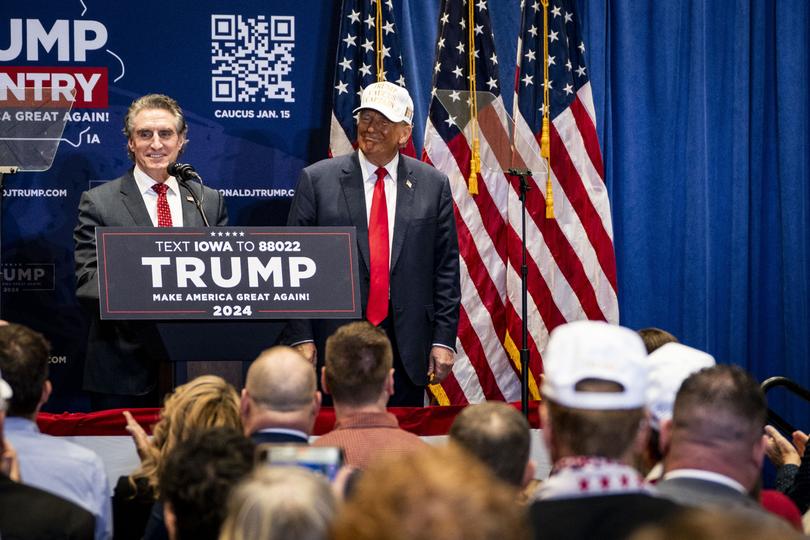 Former President Donald Trump listens as North Dakota Gov. Doug Burgum endorses Trump for president during a campaign rally in Indianola, Iowa, on Sunday, Jan. 14, 2024, the day before the Iowa caucuses. (Haiyun Jiang/The New York Times)