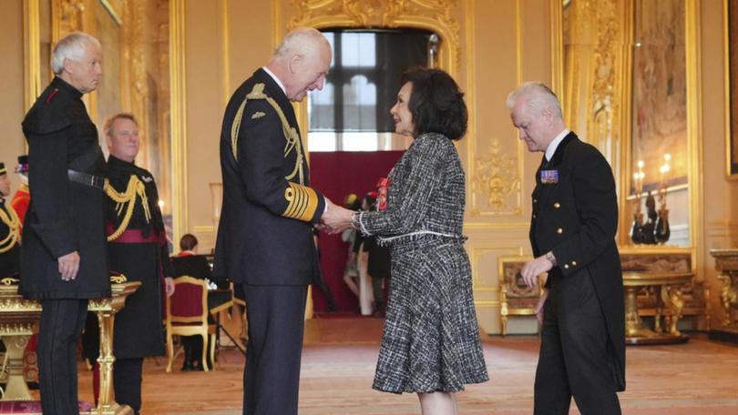 Shirley Bassey grabbed the King's hands "because I forgot to curtsy" at her investiture. (AP PHOTO)