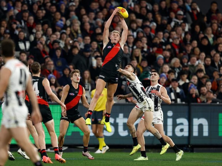 MELBOURNE, AUSTRALIA - JULY 05: Nate Caddy of the Bombers marks the ball over Oleg Markov of the Magpies during the 2024 AFL Round 17 match between the Collingwood Magpies and the Essendon Bombers at Melbourne Cricket Ground on July 05, 2024 in Melbourne, Australia. (Photo by Michael Willson/AFL Photos via Getty Images)