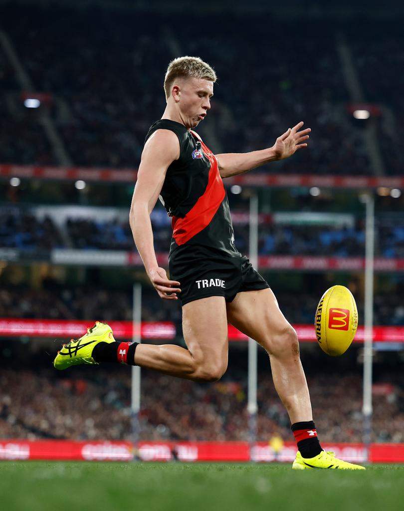 MELBOURNE, AUSTRALIA - JULY 05: Nate Caddy of the Bombers kicks the ball during the 2024 AFL Round 17 match between the Collingwood Magpies and the Essendon Bombers at Melbourne Cricket Ground on July 05, 2024 in Melbourne, Australia. (Photo by Michael Willson/AFL Photos via Getty Images)