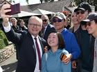 Prime Minister Anthony Albanese poses for selfies  with supporters at the Mount Coot-tha Lookout in Brisbane.