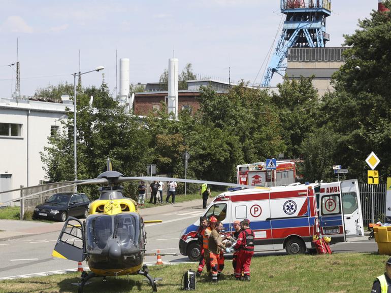 Rescuers transport an injured miner to an airborne ambulance near the Rydultowy coal mine near the city of Rybnik, in southern Poland, 