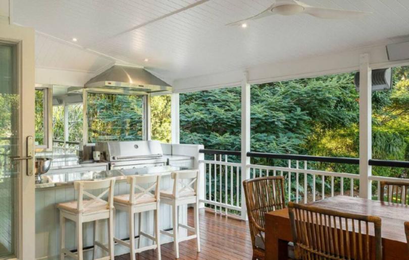 Outdoor living, including this verandah dining area, is a feature of the typical Queenslander style home once owned by the cricket great.