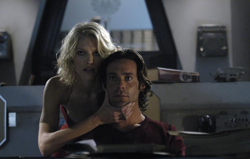 Tricia Helfer and James Callis as Six and Gaius in BSG.