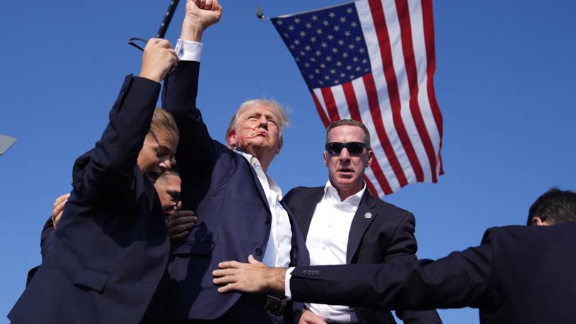 Republican presidential candidate former President Donald Trump is surrounded by U.S. Secret Service agents at a campaign rally, Saturday, July 13, 2024, in Butler, Pa. (AP Photo/Evan Vucci)