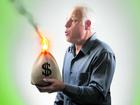 Senior man trying to blow out bag of money on fire