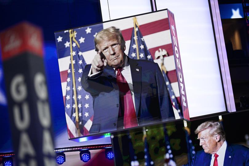 Images of Donald Trump appear on stage screens in the Fiserv Forum on the day before the Republican National Convention in Milwaukee.