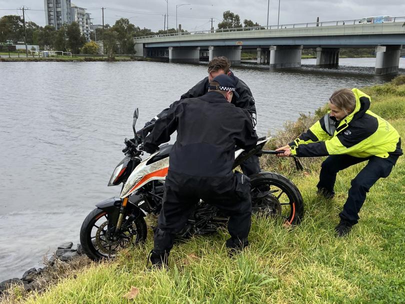 Police were seem removing a motorbike which had been found at the bottom of the river.