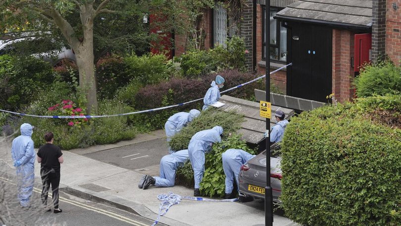 Forensic officers examine a west London address after human remains were found in two suitcases. (AP PHOTO)