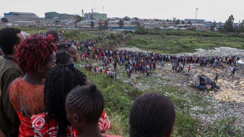 Bodies wrapped in bags are retrieved from a quarry in the Embakasi area of Nairobi. (EPA PHOTO)