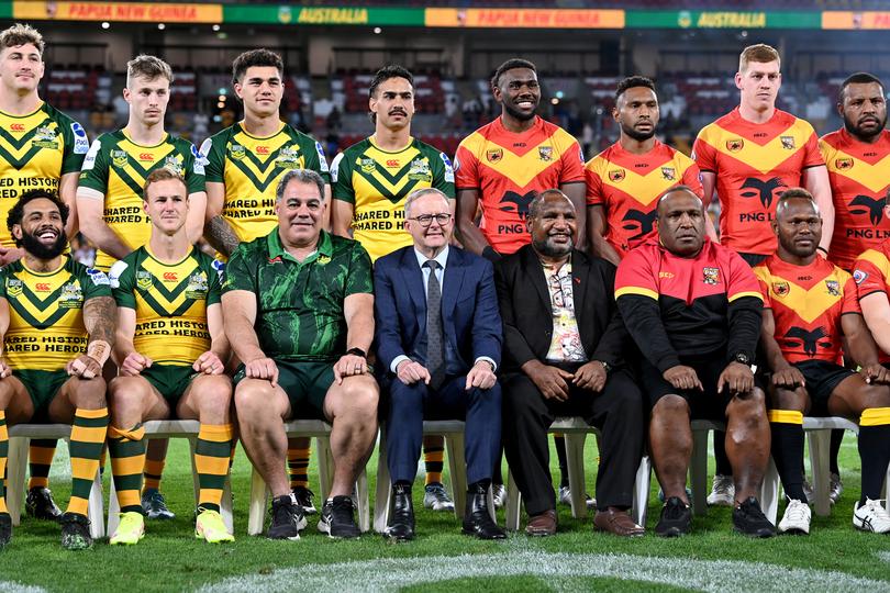 The Australia and Papua New Guinea prime ministers with their respective teams at a match in 2022.