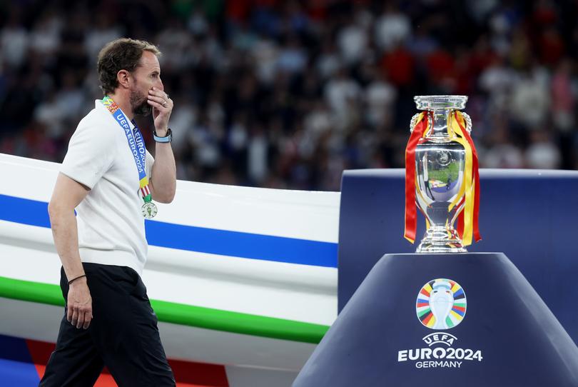 BERLIN, GERMANY - JULY 14: Gareth Southgate, Head Coach of England, looks dejected as he walks past the UEFA Euro 2024 Henri Delaunay Trophy with his Runners Up Medal after the UEFA EURO 2024 final match between Spain and England at Olympiastadion on July 14, 2024 in Berlin, Germany. (Photo by Lars Baron/Getty Images)