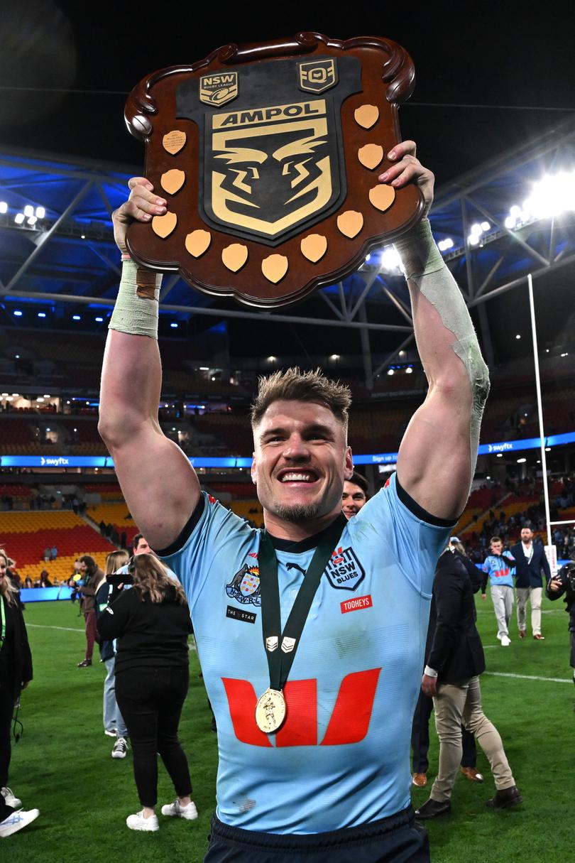 BRISBANE, AUSTRALIA - JULY 17: Angus Crichton of the Blues poses with the State of Origin Shield after winning the series 2-1 after game three of the 2024 Men's State of Origin series between Queensland Maroons and New South Wales Blues at Suncorp Stadium on July 17, 2024 in Brisbane, Australia. (Photo by Bradley Kanaris/Getty Images)