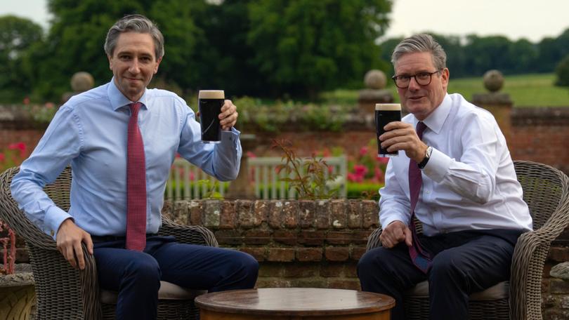 British Prime Minister Keir Starmer, right, and Irish Taoiseach Simon Harris drink a pint of Guinness in the first face-to-face meeting for the leaders since the UK general election.