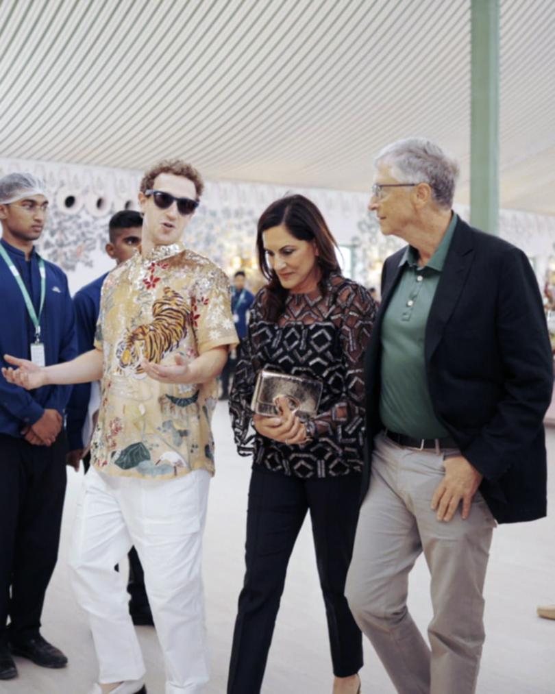 Mark Zuckerberg talks to Bill Gates, right, walking with Paula Hurd, centre, at the pre-wedding bash.