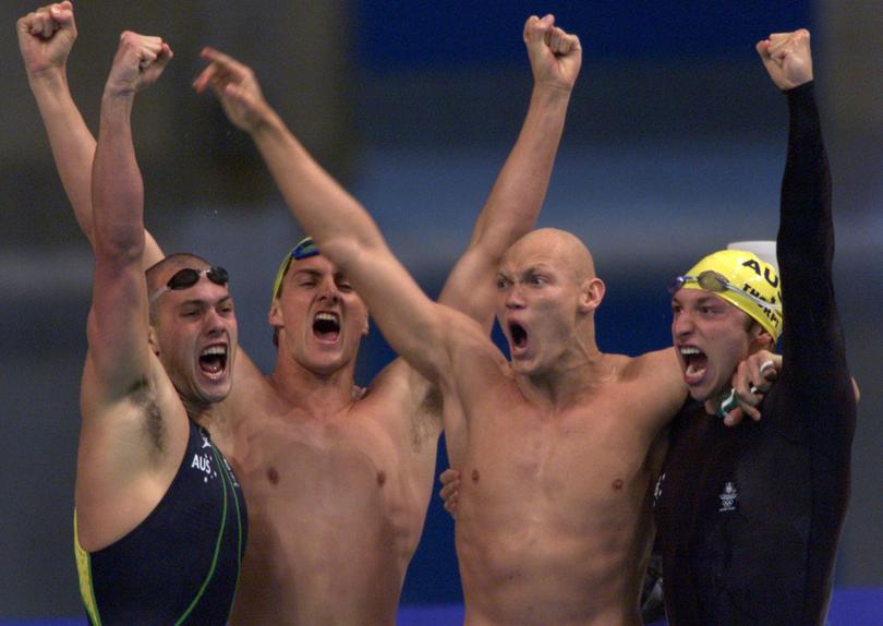 Australia's Ian Thorpe (R) celebrates with teammates Michael Klim (2nd R), Chris Fydler and Ashley Callus (L) after winning gold.