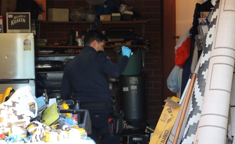 Police searching one of the homes.