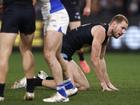 MELBOURNE, AUSTRALIA - JULY 21:  Harry McKay of the Blues is helped to his feet after a heavy collision during the round 19 AFL match between Carlton Blues and North Melbourne Kangaroos at Marvel Stadium, on July 21, 2024, in Melbourne, Australia. (Photo by Darrian Traynor/Getty Images)