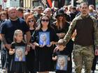 Relatives of Ukrainian former MP Iryna Farion carry her photos during her funeral procession in Lviv.