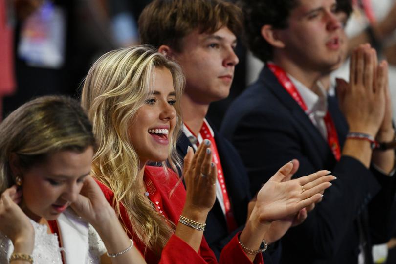 A group of younger attendees applaud after a benediction by the Rev. Corey Brooks during the second day of the Republican National Convention.