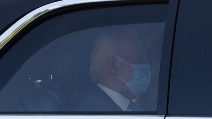 President Joe Biden wears a mask while returning to the White House from his Rehoboth Beach home after recovering from a COVID-19 infection.