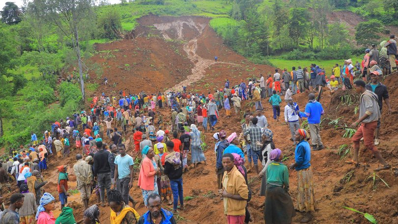 Hundreds of people gather at the site of the mudslide in southern Ethiopia.