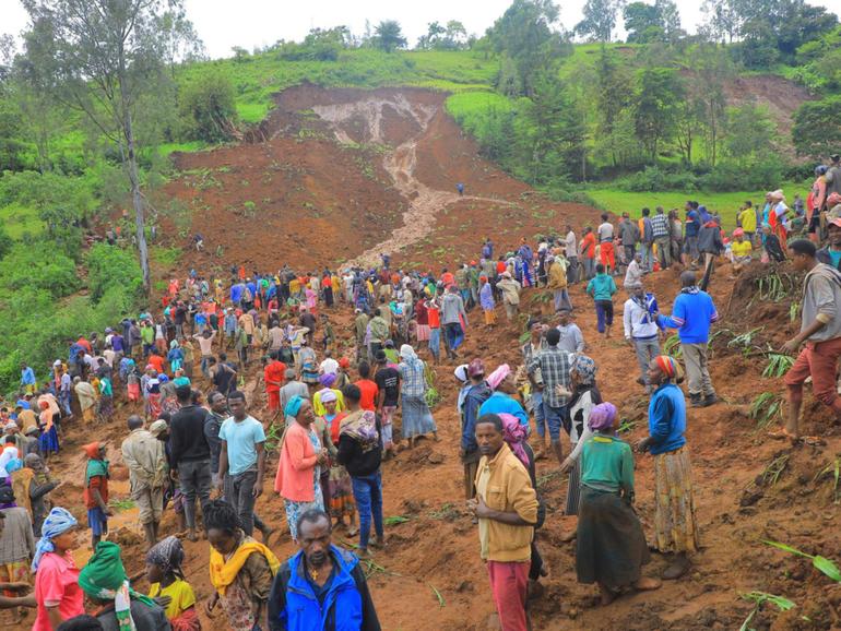 Hundreds of people gather at the site of the mudslide in southern Ethiopia.