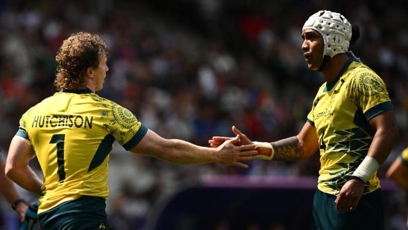 Henry Hutchison and Dietrich Roache celebrate a try in Australia's narrow win over Samoa.