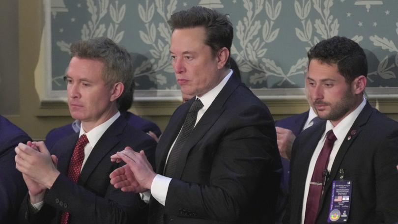 Elon Musk, center, stands up to applaud Israeli Prime Minister Benjamin Netanyahu's remarks during a joint meeting of Congress at the Capitol in Washington, Wednesday, July 24, 2024. 