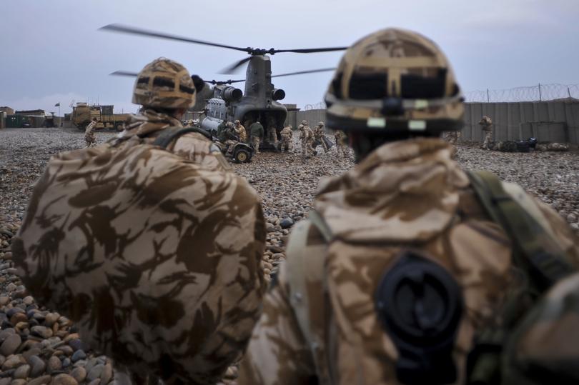 Soldiers preparing to board a Chinook helicopter at a Forward Operating Base (FOB) in the Darvishan district of Helmand Province, Afghanistan.