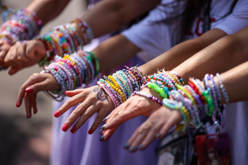 Taylor Swift fans wear bracelets on their wrists as they arrive before she performs as part of her The Eras Tour in Melbourne.