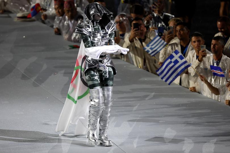 PARIS, FRANCE - JULY 26: The Olympic Flag is presented by the The Horsewoman at Place du Trocadero during the opening ceremony of the Olympic Games Paris 2024 on July 26, 2024 in Paris, France. . (Photo by Jamie Squire/Getty Images)