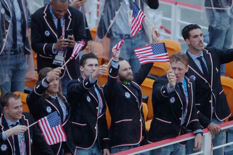 PARIS, FRANCE - JULY 26: Athletes of Team United States are seen waving their hand held flags on a boat along the River Seine during the opening ceremony of the Olympic Games Paris 2024 on July 26, 2024 in Paris, France. (Photo by Alex Pantling/Getty Images)