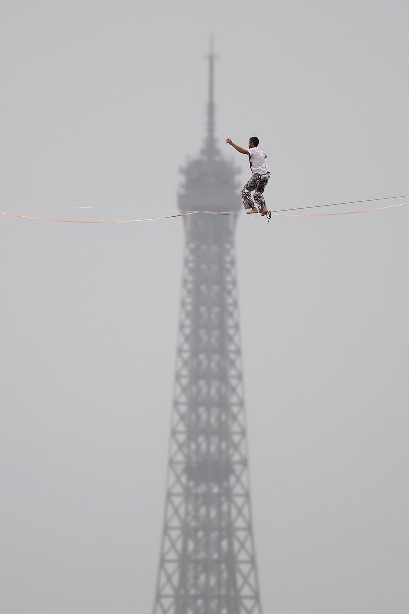 PARIS, FRANCE - JULY 26: Tightrope walker Nathan Paulin performs on a high rope during the athletes’ parade on the River Seine near the Supreme Court during the opening ceremony of the Olympic Games Paris 2024 on July 26, 2024 in Paris, France.
 (Photo by Buda Mendes/Getty Images)