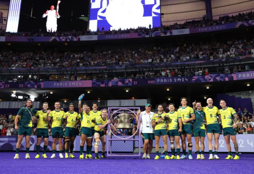 Australian players celebrate after sinking the US in the quarter-final at Stade de France.