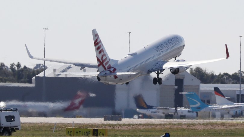 The man was restrained by crew members as the flight returned to Perth Airport less than an hour after taking off.