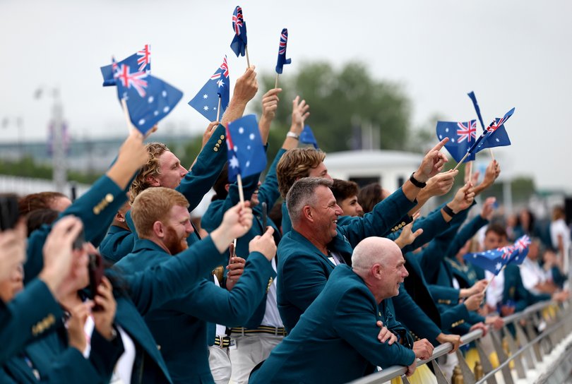 PARIS, FRANCE - JULY 26: Athletes of Team Australia wave flags on the team boat on the River Seine during the opening ceremony of the Olympic Games Paris 2024 on July 26, 2024 in Paris, France. (Photo by Quinn Rooney/Getty Images)