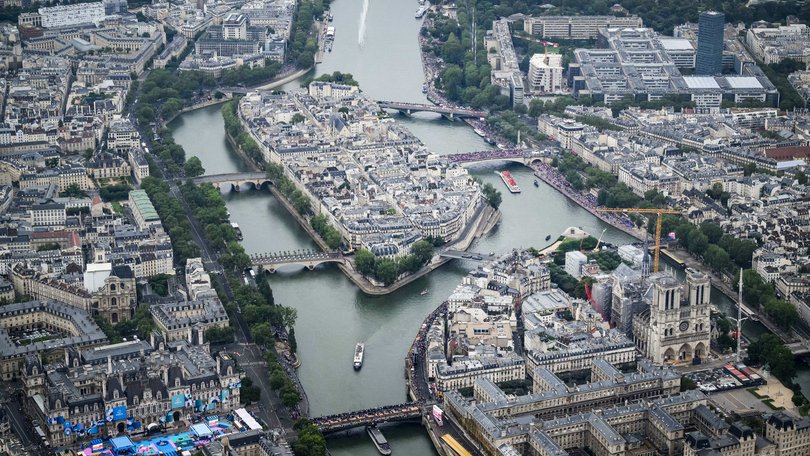 PARIS, FRANCE - JULY 26: In this aerial view taken from helicopter shows Notre-Dame de Paris Cathedral as delegations boats navigate on the Seine past the Ile de la Cite Island during the opening ceremony of the Olympic Games Paris 2024.