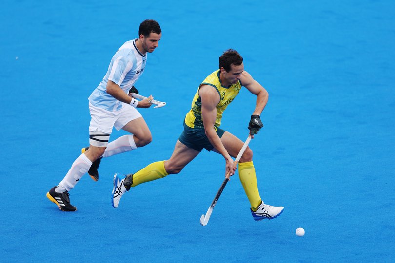 Thomas Craig of Team Australia runs with the ball whilst under pressure from Agustin Bugallo of Team Argentina.