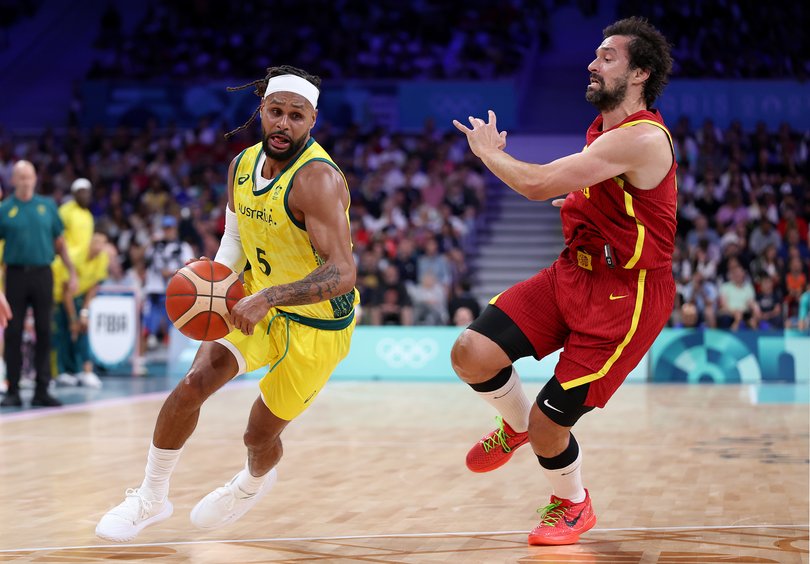 LILLE, FRANCE - JULY 27: Patty Mills #5 of Team Australia dribbles the ball against Sergio Llull #23 of Team Spain during the Men's Group Phase - Group A match between Australia and Spain on day one of the Olympic Games Paris 2024 at Pierre Mauroy Stadium on July 27, 2024 in Lille, France. (Photo by Gregory Shamus/Getty Images)